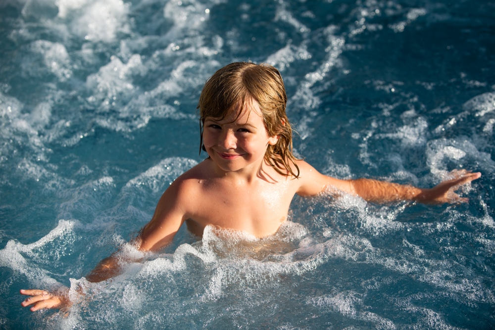 Happy kid in a swim spa